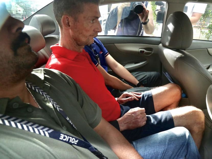 Paul Leslie Quirk (centre in car backseat) being taken to the State Courts on Jan 4, 2020.