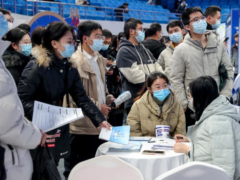 Job seekers approach the booth of an employer at a job fair in Wuhan, Hubei province, China on Feb 9, 2023. Job seekers approach the booth of an employer at a job fair in Wuhan, Hubei province, China on Feb 9, 2023.