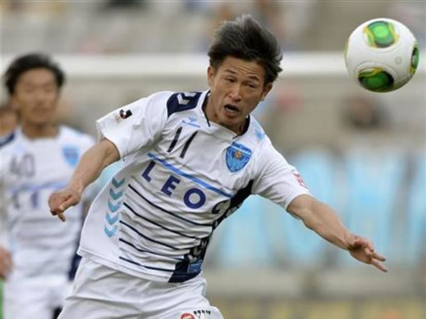 In this May 3, 2013 photo, Kazuyoshi Miura of Yokohama FC controls the ball as his team plays Tokyo Verdy during a J-League match in Tokyo. Photo: AP