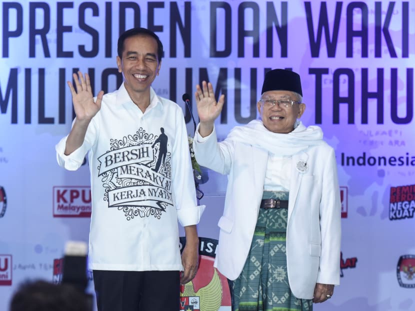 Indonesian President Joko Widodo and his running mate for the 2019 presidential election, Islamic cleric Ma'ruf Amin, wave to supporters. Indonesian President Joko Widodo and his running mate for the 2019 presidential election, Islamic cleric Ma'ruf Amin, wave to supporters.