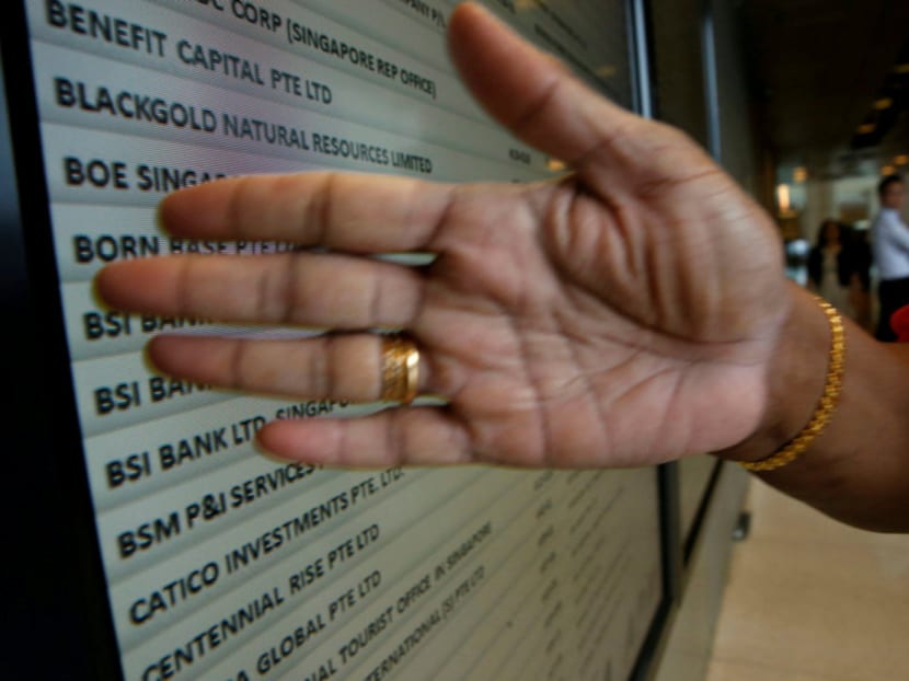 A security officer blocks a directory board showing Swiss bank BSI at their office building in Singapore May 24, 2016. Photo: Reuters