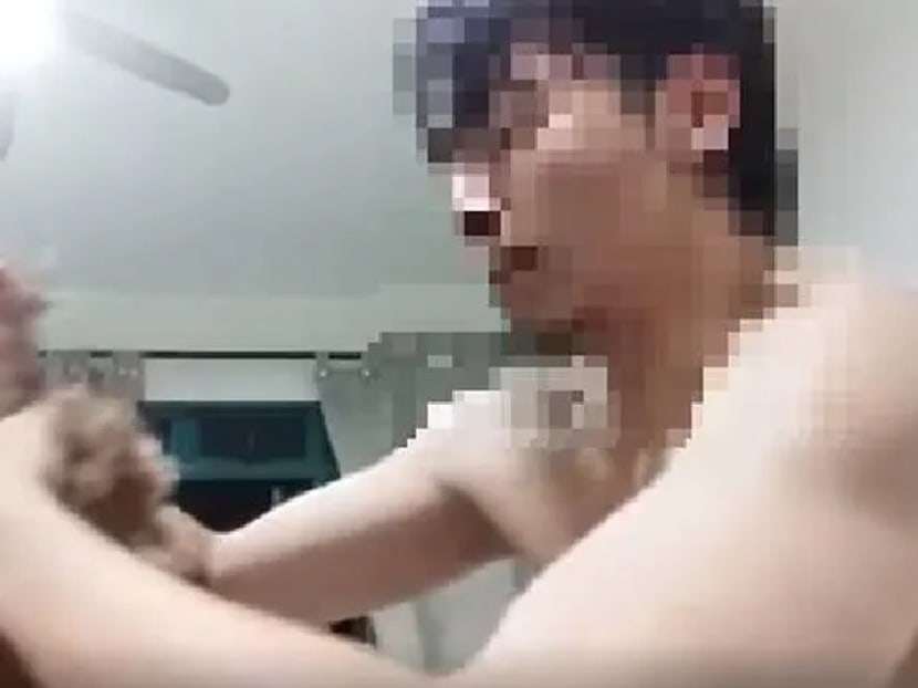 A screengrab from videos circulating online showing a dog being abused by a man.