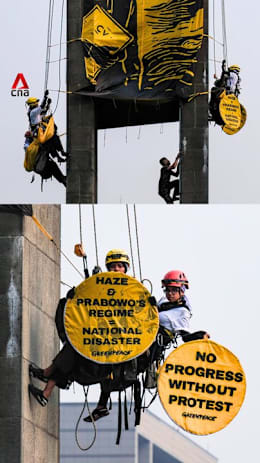 Greenpeace activists in Indonesia climb iconic statue in haze protest