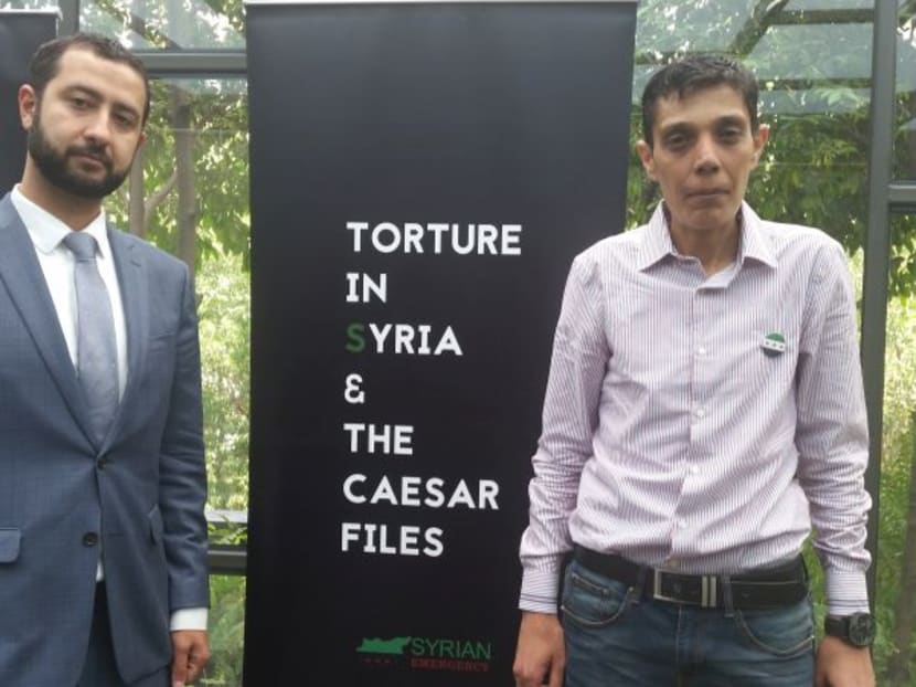 Syrian Emergency Task Force executive director Mouaz Moustafa with Syrian tortured survivor Mazen Al-Hummada, on June 10, 2017 Photo: Malay Mail Online