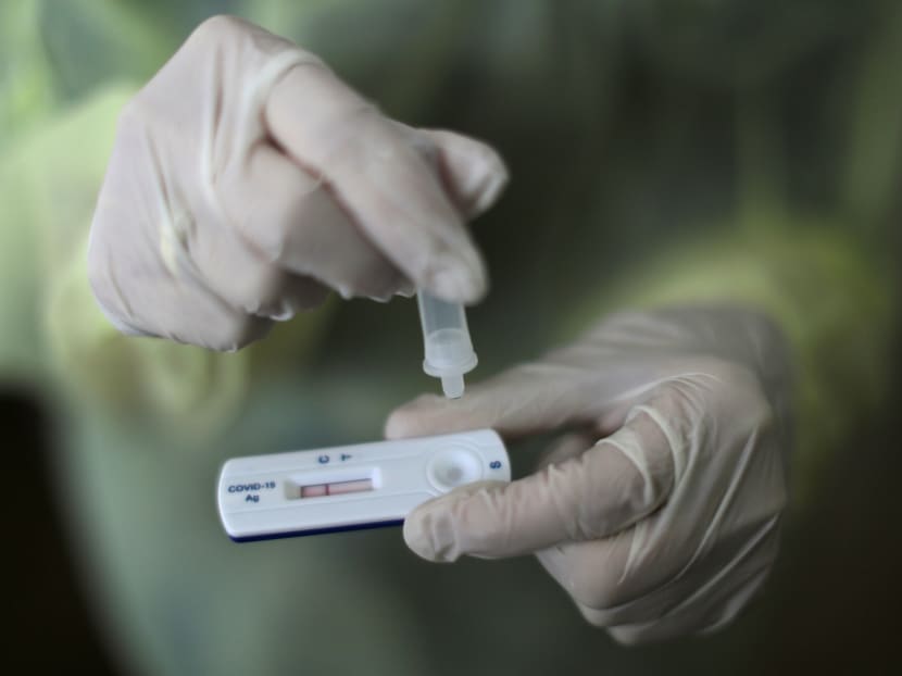 A healthcare worker performs a rapid Covid-19 antigenic test at a Covid-19 testing centre in Nice, France. A healthcare worker performs a rapid Covid-19 antigenic test at a Covid-19 testing centre in Nice, France.