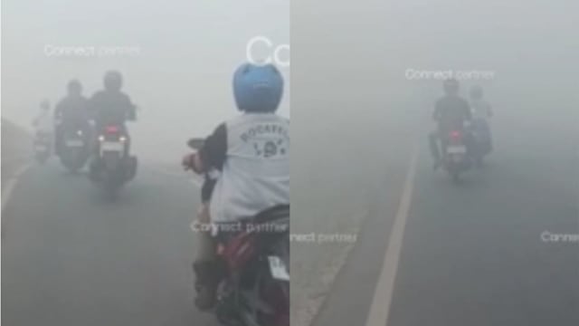 印尼林火引发烟霾 骑士浓烟中缓慢前行