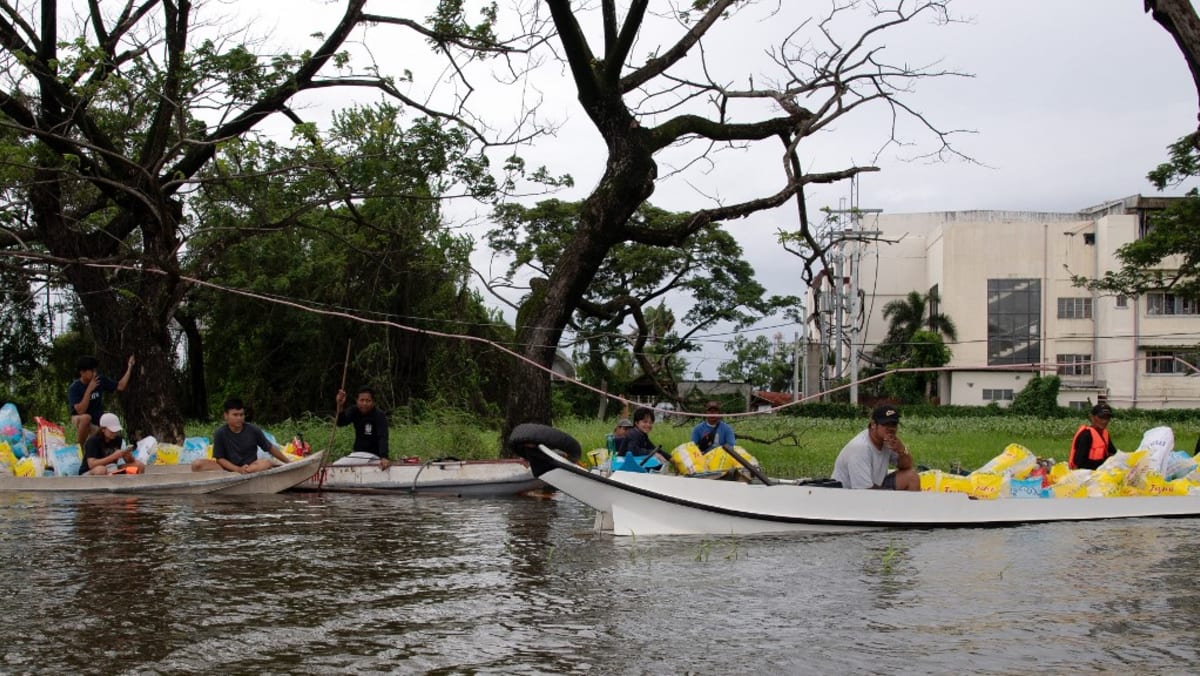 Boats bring Philippine flood victims to safety as death toll rises