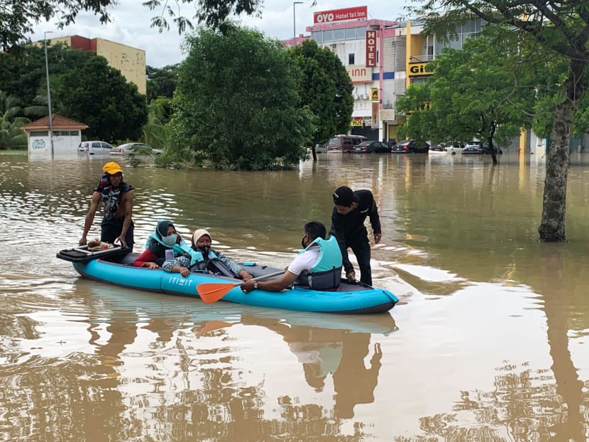 Volunteers rescue stranded flood victims from their homes inundated by flash floods caused by torrential rain in Shah Alam, Selangor state, Malaysia on Dec 19 2021. Volunteers rescue stranded flood victims from their homes inundated by flash floods caused by torrential rain in Shah Alam, Selangor state, Malaysia on Dec 19 2021.