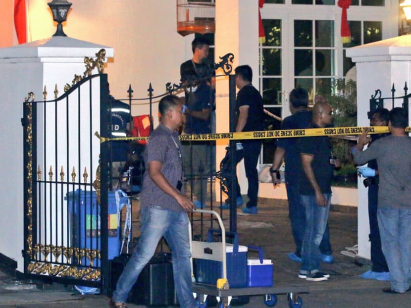 Police officers at the scene of the murder in Telok Kurau.