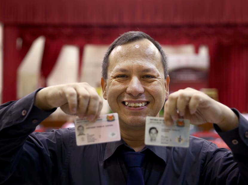 Alexander Franklin Alrivers, 50, poses for a photo with his new pink Singaporean IC and his blue IC that indicated his nationality as "stateless". He had been stateless all his life until his application for citizenship was accepted this year. Photo: Nuria Ling/TODAY Alexander Franklin Alrivers, 50, poses for a photo with his new pink Singaporean IC and his blue IC that indicated his nationality as "stateless". He had been stateless all his life until his application for citizenship was accepted this year. Photo: Nuria Ling/TODAY