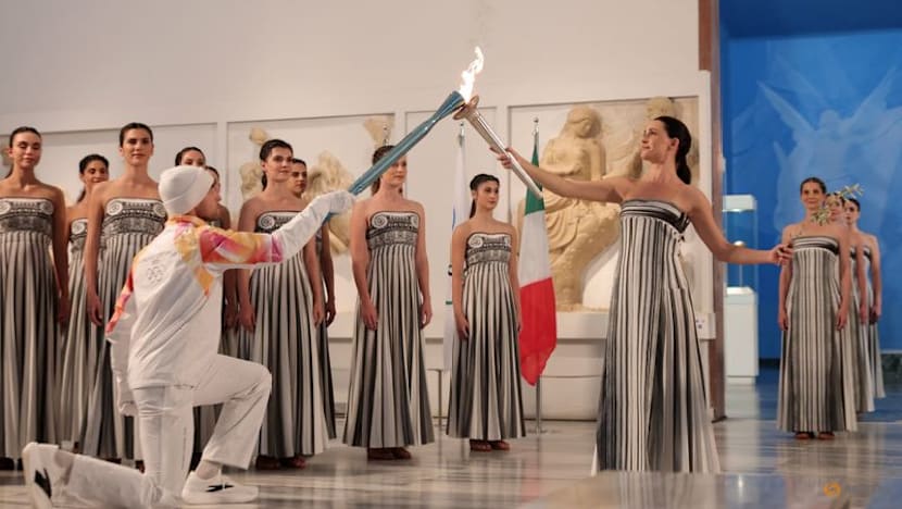 Torch for the Milano Winter Games lit in low-key indoor ceremony