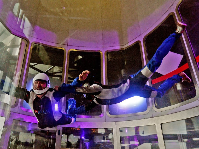 Mr Lawrence Koh (left), managing director and founder of iFly Singapore, participating in iFly Singapore's Guinness World Record of 'most tandem indoor skydives', where 230 flyers helped set the record within an hour. Photo: Robin Choo