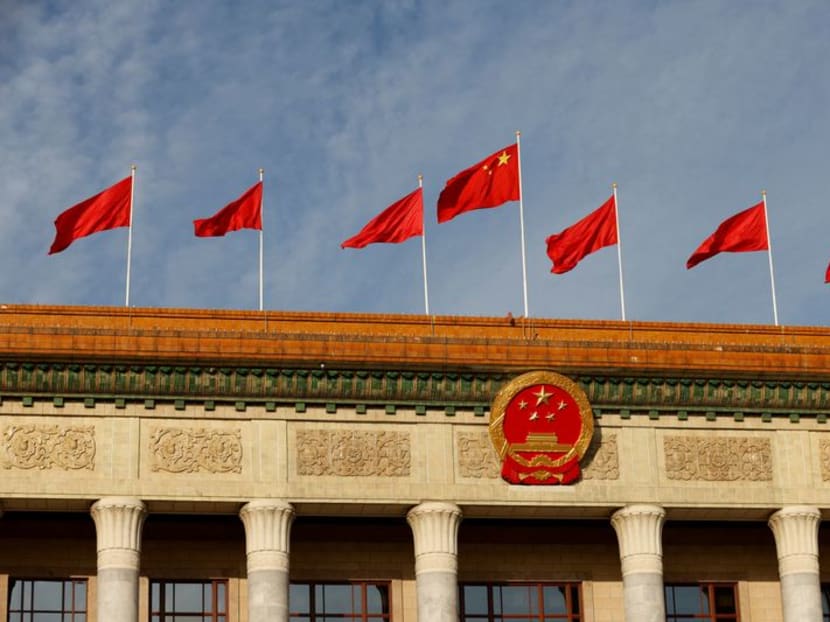 FILE PHOTO: A Chinese flag flutters on top of the Great Hall of the People ahead of the opening ceremony of the Belt and Road Forum (BRF), to mark 10th anniversary of the Belt and Road Initiative, in Beijing, China October 18, 2023. REUTERS/Edgar Su/File Photo
