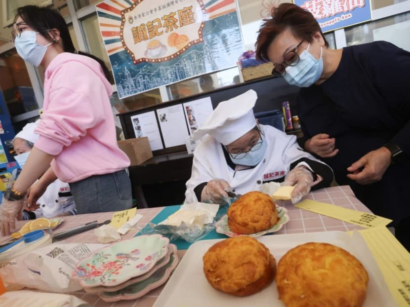 Ms Mandy Lau watches over 93-year-old Wong Shui-ying at Shing Kee Cafe, which has pineapple buns among items on the menu. Ms Mandy Lau watches over 93-year-old Wong Shui-ying at Shing Kee Cafe, which has pineapple buns among items on the menu.
