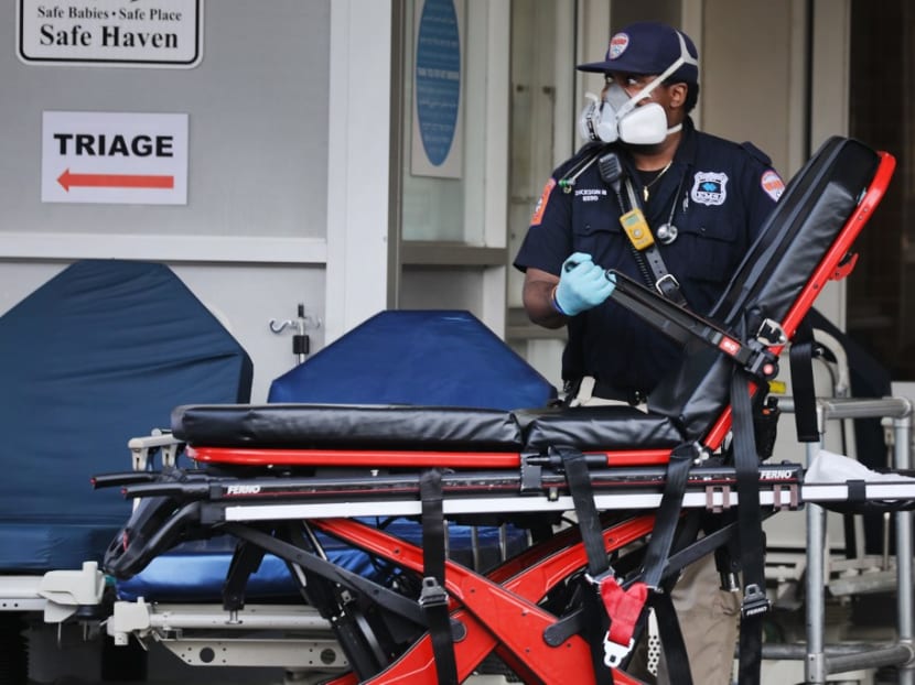 Medical workers take in patients outside a special coronavirus area at Maimonides Medical Center as the US surpasses 100,000 fatalities from Covid-19 on May 27, 2020 in New York City.