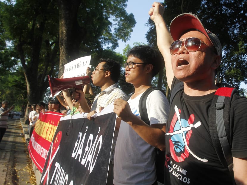 Protesters hold a placard which reads "Down with Xi Jinping's gang" during an anti-China protest in front of the Chinese embassy in Hanoi yesterday.  Photo: Reuters