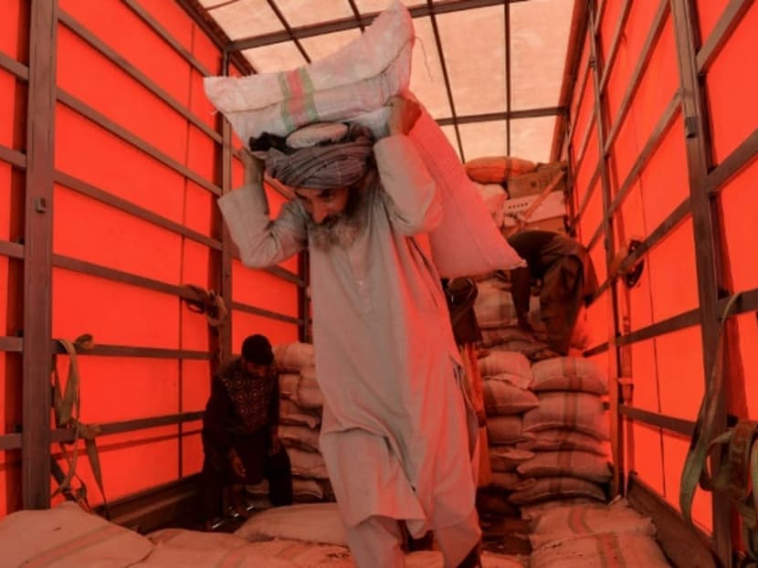 A labourer unloads a truck at the Herat customs port