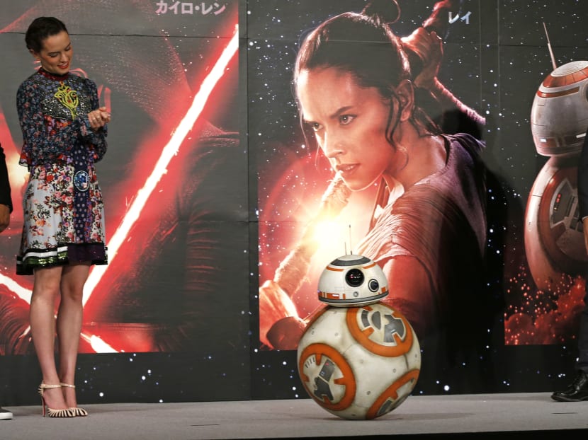 Director JJ Abrams, right, and actress Daisy Ridley look on BB-8 droid during a press conference for their latest film "Star Wars: The Force Awakens" at a hotel in Urayasu, near Tokyo. Photo: AP Director JJ Abrams, right, and actress Daisy Ridley look on BB-8 droid during a press conference for their latest film "Star Wars: The Force Awakens" at a hotel in Urayasu, near Tokyo. Photo: AP