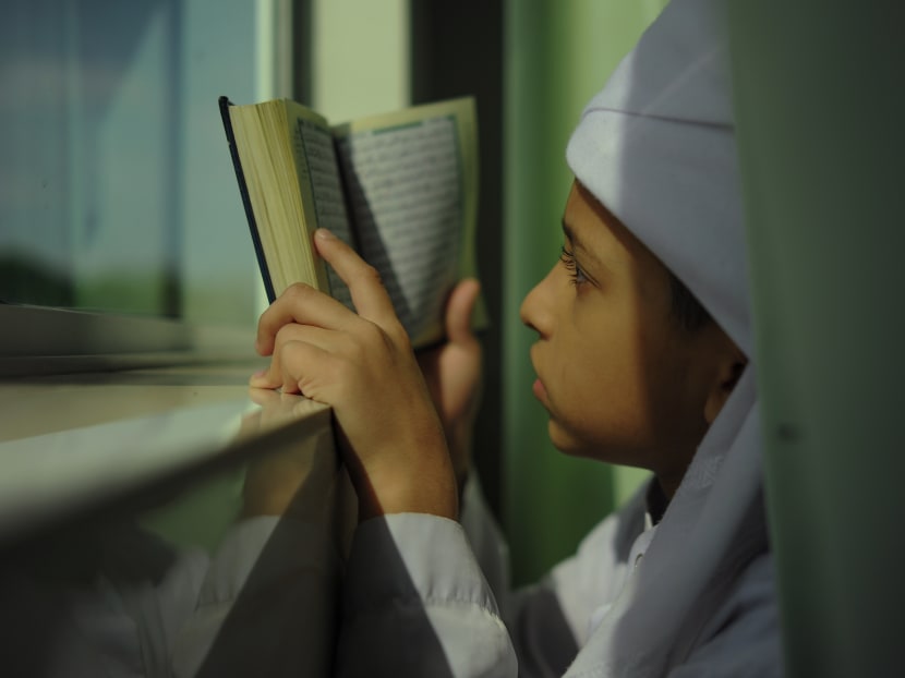 A Malaysian Muslim boy reading the Koran during the holy fasting month of Ramadan in Malaysia. Photo: AFP