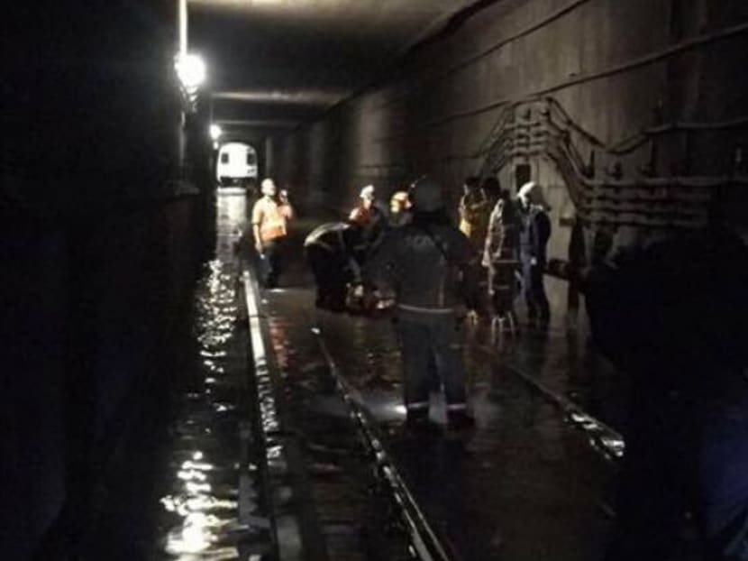 SCDF personnel work to clear a flooded tunnel between Braddell and Bishan MRT stations on Oct 8. Photo: SCDF