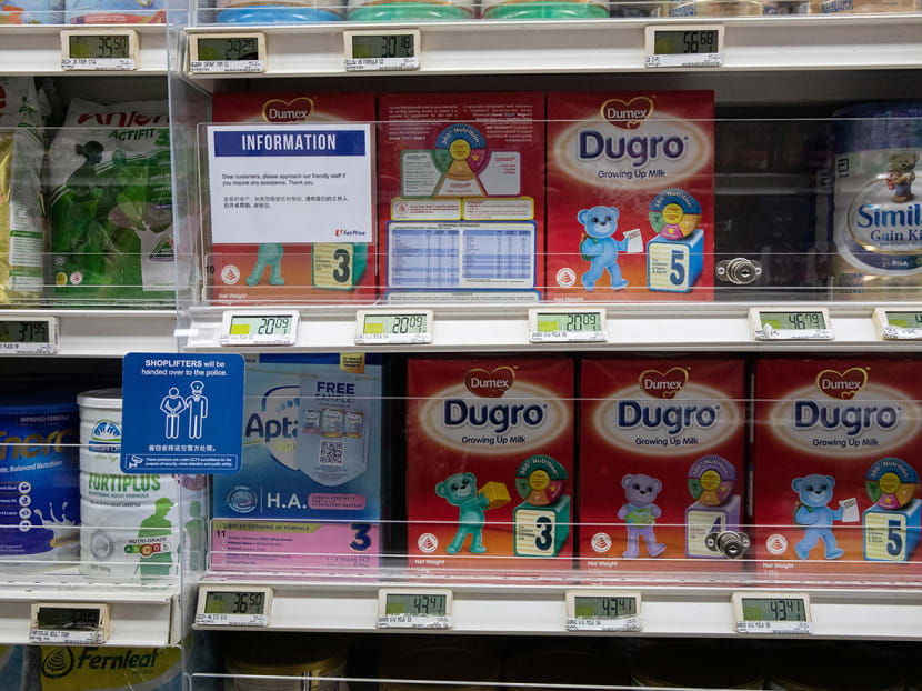 Shelves of baby milk powder locked behind screens at an NTUC FairPrice supermarket in Bukit Batok on Jan 18, 2023. 