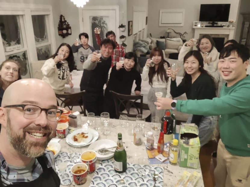 Mr Alexander Campagna (left most) and his wife, Andrea, with the nine stranded South Korean tourists and their driver in their home. The guests prepared Korean dishes, like spicy stir-fried pork, during the holiday weekend.