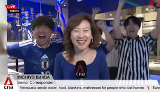 Japan fans celebrate as the team progresses to the World Cup knockout stage