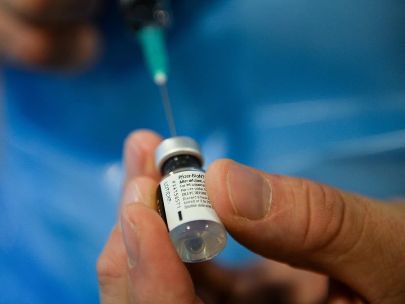 A member of the medical staff prepares a dose of the Pfizer/BioNtech Covid-19 vaccine at the Notre-Dame hospital in Brussels, Belgium on Dec 28, 2020.