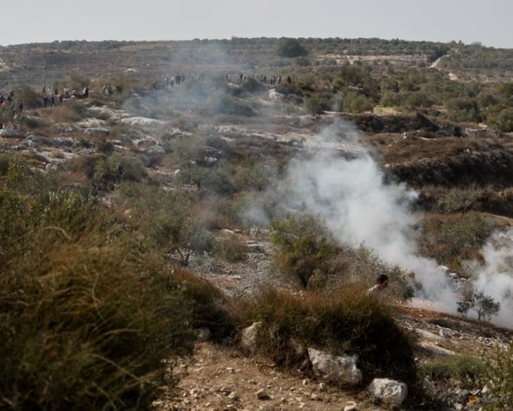 Masked Israeli settlers torch property, injure four Palestinians, army says