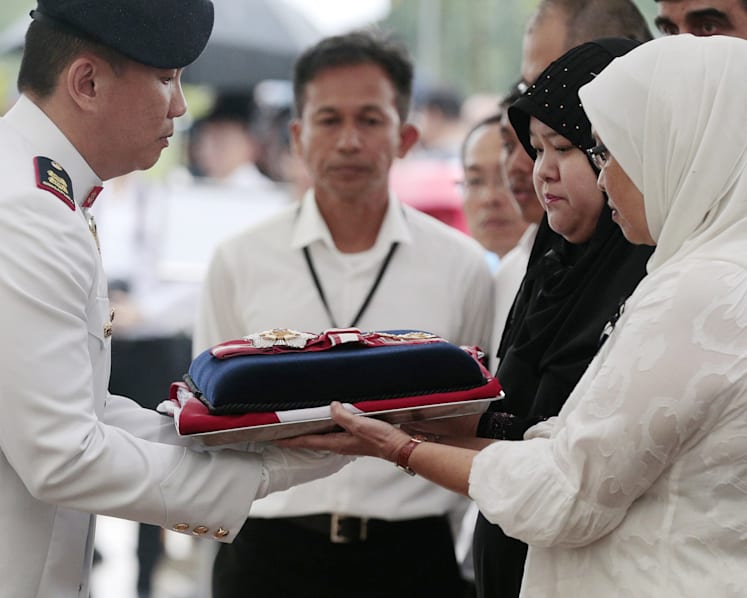 Crowds brave torrential downpour as Othman Wok is laid to rest