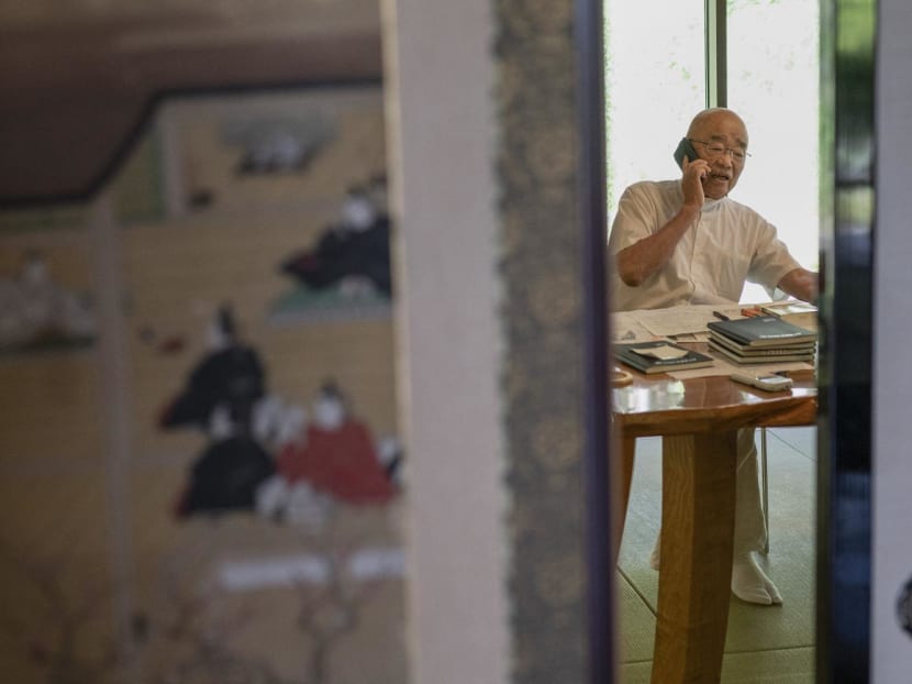 This photo taken on Sept 5, 2023 shows chief Buddhist priest Eiichi Shinohara speaking on the phone at the end of an interview with AFP at his temple near the city of Narita, Chiba prefecture.
