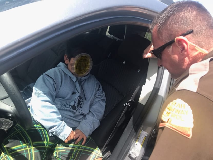 A photo released by the Utah Highway Patrol shows an officer speaking to a 5-year old boy that was pulled over after driving down the highway in Weber County near Ogden, Utah, on May 4, 2020. A photo released by the Utah Highway Patrol shows an officer speaking to a 5-year old boy that was pulled over after driving down the highway in Weber County near Ogden, Utah, on May 4, 2020.
