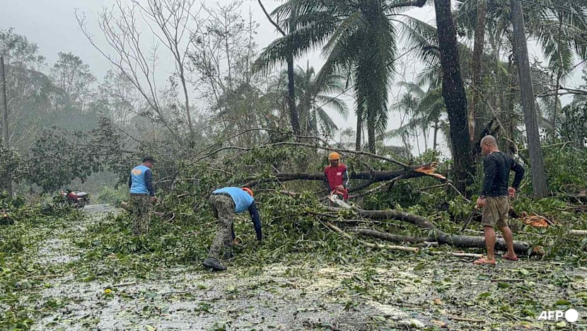 Floods strand people on roofs as typhoon pounds Philippines