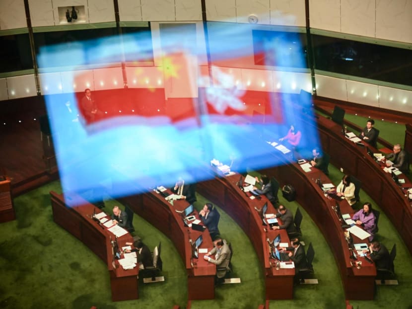 A view of the Legislative Council chamber with China and Hong Kong flags reflected on the window as the second reading of the Article 23 security law continues, in Hong Kong on March 19, 2024. A view of the Legislative Council chamber with China and Hong Kong flags reflected on the window as the second reading of the Article 23 security law continues, in Hong Kong on March 19, 2024.