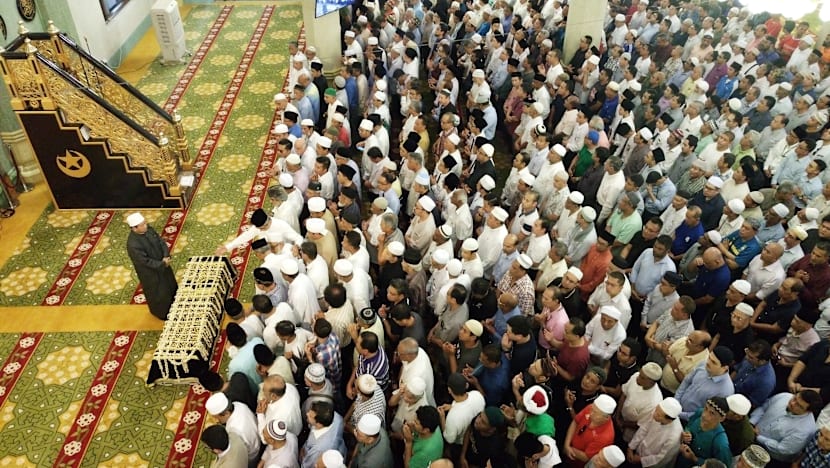 Crowds brave torrential downpour as Othman Wok is laid to rest