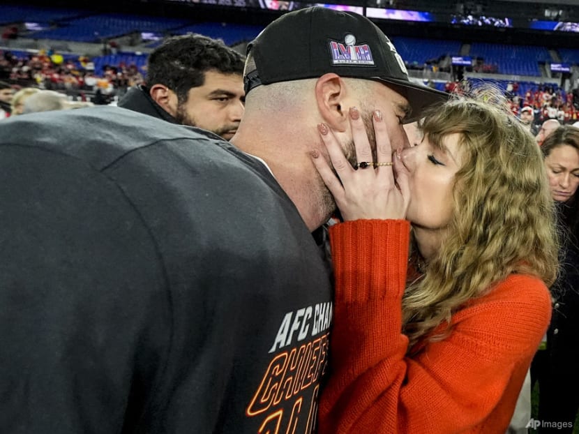 Taylor Swift greets Super Bowl-bound Travis Kelce with a kiss after Kansas City Chiefs win the AFC title game