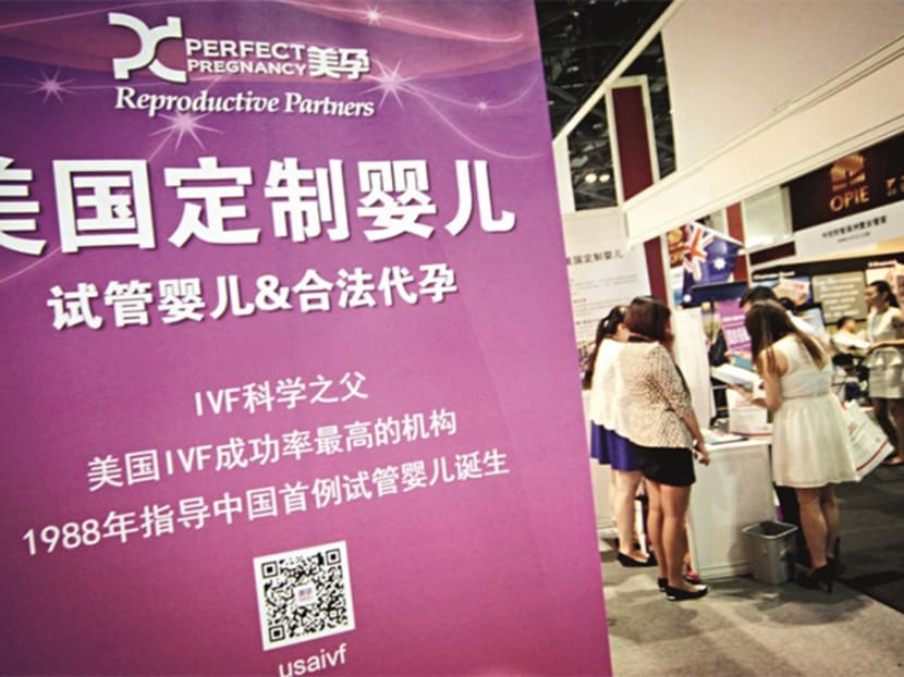 A surrogacy agency introduces test tube baby service and legal surrogate in U.S. to their Chinese customers in an exhibition in Beijing, on July 4, 2014. Photo: Caixin Online