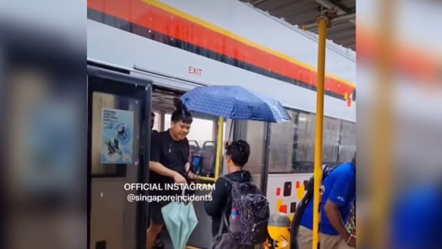 男学生雨中为下车乘客撑伞获网赞