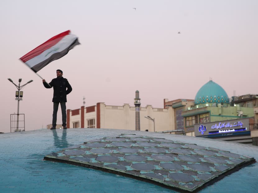A man celebrates after Iran launched missiles at US-led forces in Iraq, in Tehran, Iran, on Wednesday, January 8, 2020.