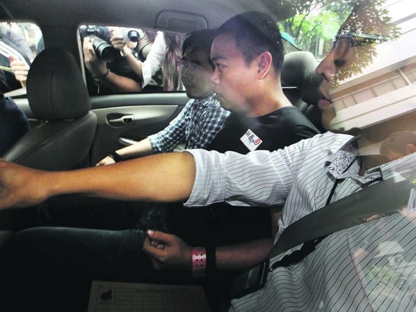 Iskandar Rahmat (second from right), a 14-year veteran of the police force, had killed a car workshop owner and the man’s son on July 10, 2013. Iskandar Rahmat (second from right), a 14-year veteran of the police force, had killed a car workshop owner and the man’s son on July 10, 2013.