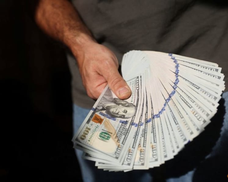Dollar edges lower against yen in week packed with data releases and central bank decisions