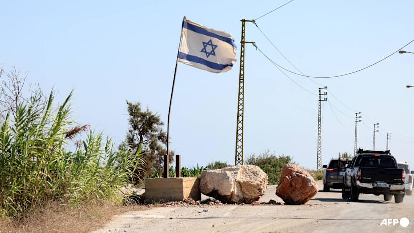 In south Lebanon, Israel flag and checkpoint mark start of occupation