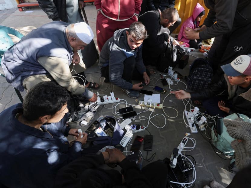 Palestinians charge their devices outside the Emirati hospital, amid the ongoing conflict between Israel and the Palestinian Islamist group Hamas, in Rafah in the southern Gaza Strip on Jan 15, 2024. 