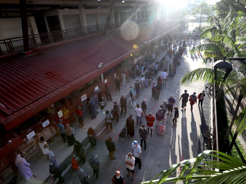 A view of the Geylang Serai market at 8am on May 21, 2020, when there were long queues at both its entrances. A view of the Geylang Serai market at 8am on May 21, 2020, when there were long queues at both its entrances.