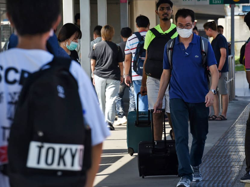 People arriving at Woodlands checkpoint in Singapore on March 17, 2020. Companies who hire Malaysian workers had to scramble to find lodgings for them in Singapore when they cannot return home during Malaysia's lockdown for the rest of March. People arriving at Woodlands checkpoint in Singapore on March 17, 2020. Companies who hire Malaysian workers had to scramble to find lodgings for them in Singapore when they cannot return home during Malaysia's lockdown for the rest of March.