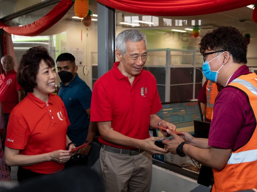 Prime Minister Lee Hsien Loong (centre) and National Trades Union Congress president Mary Liew distributing red packets to SMRT staff members during Mr Lee's Chinese New Year visit to the Woodlands Integrated Transport Hub on Jan 21, 2023. Prime Minister Lee Hsien Loong (centre) and National Trades Union Congress president Mary Liew distributing red packets to SMRT staff members during Mr Lee's Chinese New Year visit to the Woodlands Integrated Transport Hub on Jan 21, 2023.