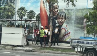 Two charged for instructing foreign workers to hold placards in illegal protests at construction site