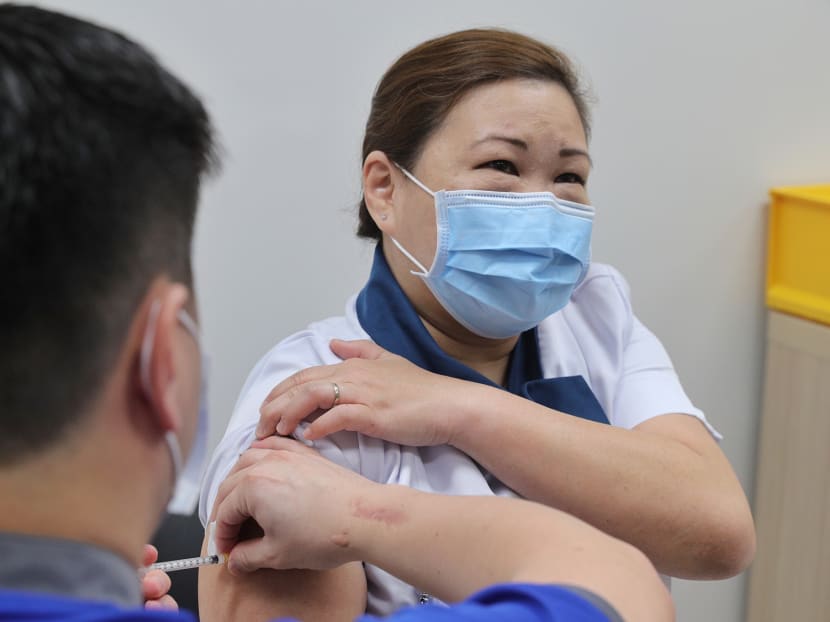 Senior staff nurse Sarah Lim at the National Centre for Infectious Diseases receives one of the first doses of the Covid-19 vaccine in Singapore on Dec 30, 2020.
