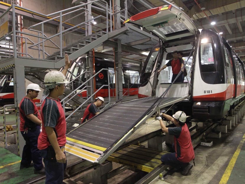 SMRT staff at work at SMRT Kim Chuan Depot doing regular tests and maintenance on a train. TODAY file photo