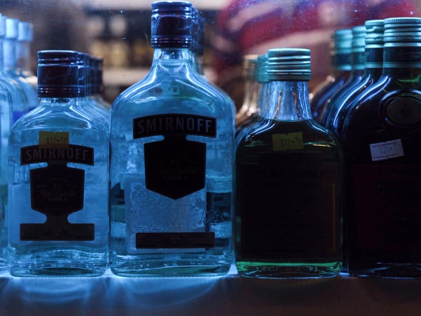 Bottles of alcoholic beverages on a shelf at a liquor store in Little India.